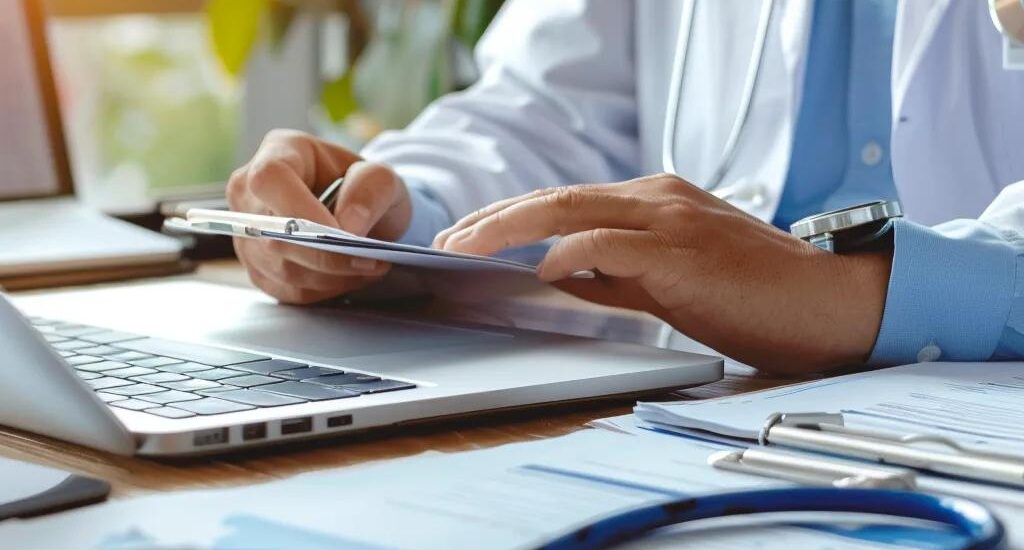 Healthcare billing professional at a desk with medical documents and a computer, emphasizing medical insurance claim procedures