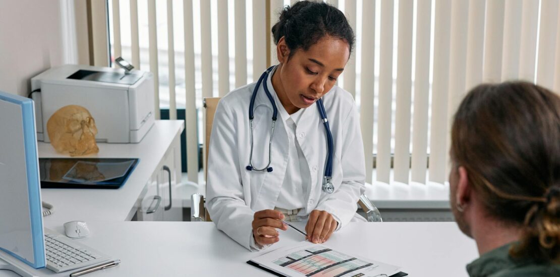 Woman in a white jacket and stethoscope filling out a paper for medical billing outsourcing. | medical billing outsourcing