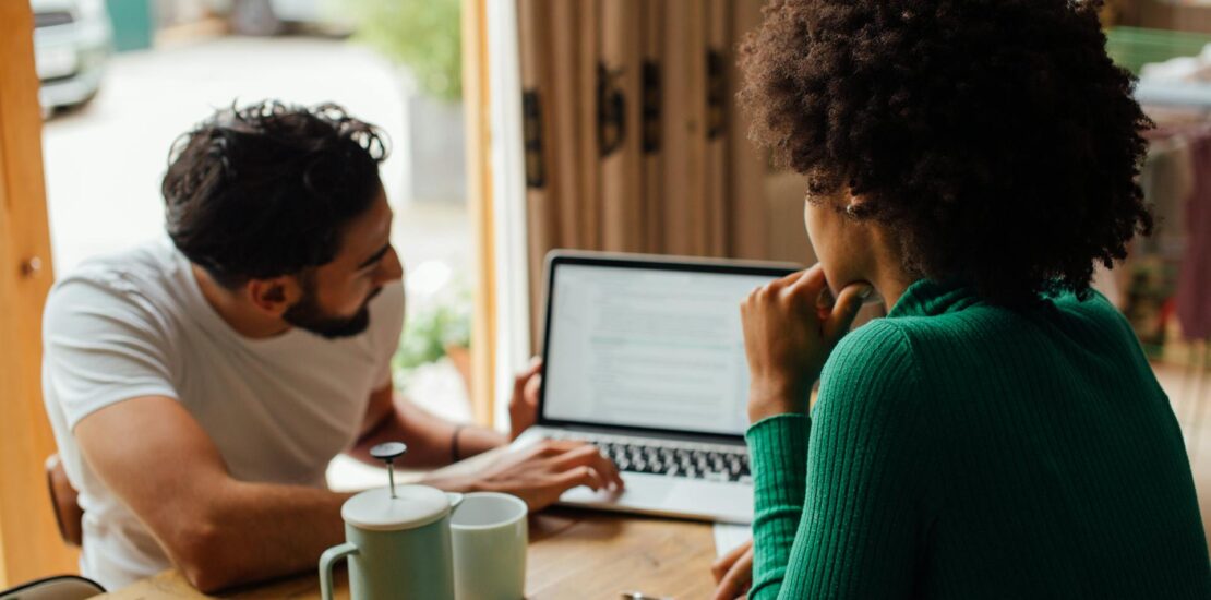 Man and woman studying medical billing terminology at coffee shop with laptop | medical billing terminology